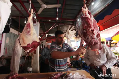 A Palestinian vendor sells meats at a market during the holy month of Ramadan, on May 24, 2018. Ramadan is sacred to Muslims because it is during that month that tradition says the Koran was revealed to the Prophet Moham...