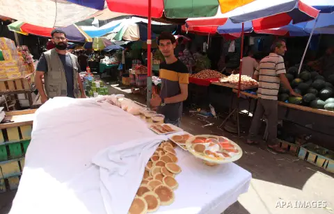 A Palestinian vendor prepares "Qatayef", traditional pancakes that are popular at a market during the holy month of Ramadan, on May 24, 2018. Ramadan is sacred to Muslims because it is during that month that tradition sa...