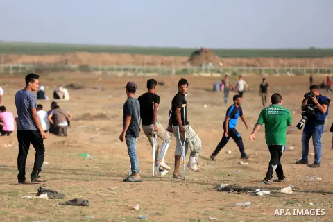 Palestinian protesters gather during clashes with Israeli security froces in a tent city protest where Palestinians demand the right to return to their homeland and against U.S. embassy move to Jerusalem at the Israel-Ga...
