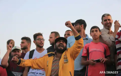 Palestinian protesters gather during clashes with Israeli security froces in a tent city protest where Palestinians demand the right to return to their homeland and against U.S. embassy move to Jerusalem at the Israel-Ga...
