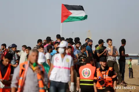 Palestinian protesters gather during clashes with Israeli security froces in a tent city protest where Palestinians demand the right to return to their homeland and against U.S. embassy move to Jerusalem at the Israel-Ga...
