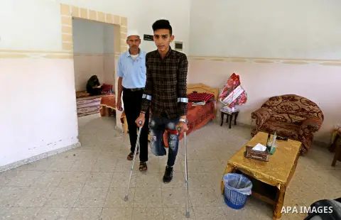 Palestinian Mohammed Musabeh, 17, a High school student, who amputated his leg after he was shot by Israeli troops during clashes in tents protest demanding the right to return to their homeland, at the Israel-Gaza borde...