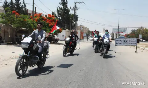 Palestinians ride motorcycles and carry the Palestinian flag during a demonstration organized by the National Authority for Return and Breaking the Siege in Gaza City, June 5, 2018. Photo by Mahmoud Ajour