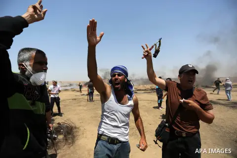 Palestinian protesters gather during clashes with Israeli troops in a protest marking al-Quds Day, (Jerusalem Day), at the Israel-Gaza border in Khan Younis in the southern Gaza Strip on June 8, 2018. Photo by Ashraf Amr...