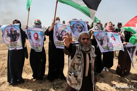 Palestinian protesters gather during clashes with Israeli troops in a protest marking al-Quds Day, (Jerusalem Day), at the Israel-Gaza border in Rafah in the southern Gaza Strip on June 8, 2018. Photo by Mahmoud Bassam