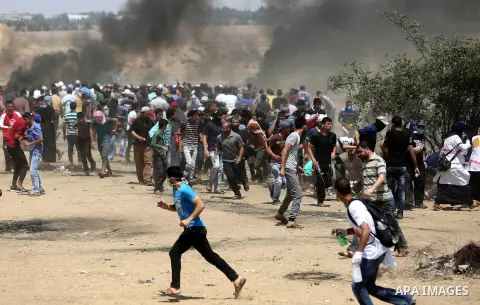 Palestinian protesters gather during clashes with Israeli troops in a protest marking al-Quds Day, (Jerusalem Day), at the Israel-Gaza border in Khan Younis in the southern Gaza Strip on June 8, 2018. Photo by Ashraf Amr...