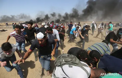Palestinian protesters gather during clashes with Israeli troops in a protest marking al-Quds Day, (Jerusalem Day), at the Israel-Gaza border in Khan Younis in the southern Gaza Strip on June 8, 2018. Photo by Ashraf Amr...
