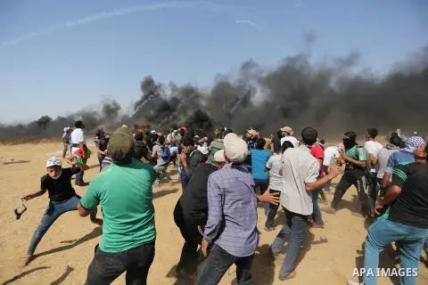 Palestinian protesters gather during clashes with Israeli troops in a protest marking al-Quds Day, (Jerusalem Day), at the Israel-Gaza border in Khan Younis in the southern Gaza Strip on June 8, 2018. Photo by Ashraf Amr...