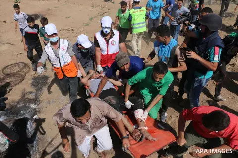 A wounded Palestinian protester is evacuated during clashes with Israeli security froces in a protest marking al-Quds Day, (Jerusalem Day), at the Israel-Gaza border in al-Bureij in the center of Gaza Strip on June 8, 20...