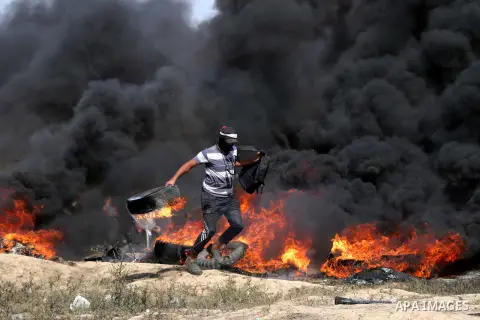 Palestinian protesters gather during clashes with Israeli troops in a protest marking al-Quds Day, (Jerusalem Day), at the Israel-Gaza border in al-Bureij in the center of Gaza Strip on June 8, 2018. Photo by Mahmoud Kha...