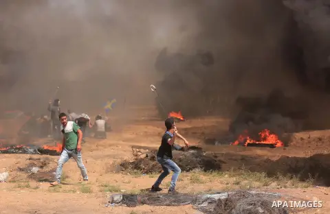 Palestinian protesters gather during clashes with Israeli troops in a protest marking al-Quds Day, (Jerusalem Day), at the Israel-Gaza border in east of Gaza city, on June 8, 2018. Photo by Dawoud Abo Alkas