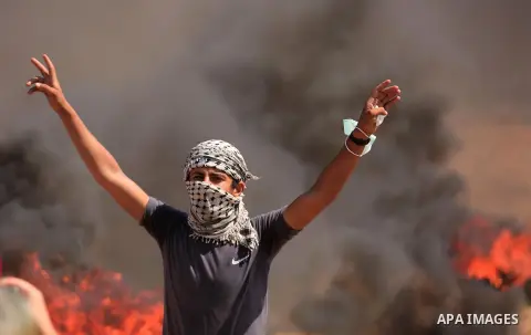 Palestinian protesters gather during clashes with Israeli troops in a protest marking al-Quds Day, (Jerusalem Day), at the Israel-Gaza border in east of Gaza city, on June 8, 2018. Photo by Dawoud Abo Alkas