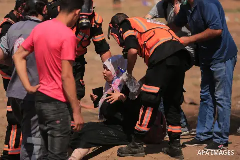 A wounded Palestinian protester is evacuated during clashes with Israeli security froces in a protest marking al-Quds Day, (Jerusalem Day), at the Israel-Gaza border in east of Gaza city, on June 8, 2018. Photo by Dawoud...