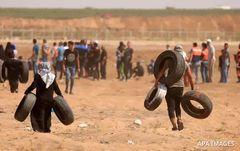 Palestinian protesters gather during clashes with Israeli troops in a protest marking al-Quds Day, (Jerusalem Day), at the Israel-Gaza border in east of Gaza city, on June 8, 2018. Photo by Dawoud Abo Alkas