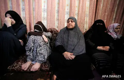 Relatives of Palestinian Haitham al-Jamal, 15, who was shot dead by Israeli troops during clashes, mourn during his funeral in Rafah in the southern Gaza Strip on June 9, 2018. Four Palestinians were killed by Israeli fi...