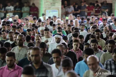 Palestinian Muslim worshippers pray overnight on on June 11, 2018 at the al-Omary mosque in Gaza city on the occasion of Laylat al-Qadr which falls on the 27th day of the fasting month of Ramadan. Laylat al-Qadr, or Nigh...