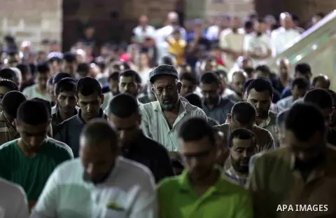 Palestinian Muslim worshippers pray overnight on on June 11, 2018 at the al-Omary mosque in Gaza city on the occasion of Laylat al-Qadr which falls on the 27th day of the fasting month of Ramadan. Laylat al-Qadr, or Nigh...