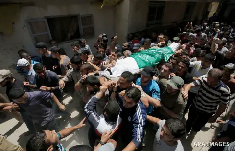 Mourners carry the body of Palestinian of Ahmed al-Assi, 21, who died of his wounds endured during clashes with Israeli troops in a tent city protest where Palestinians demand the right to return to their homeland at the...