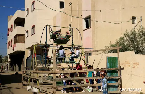Palestinian children enjoy the first day of Eid al-Fitr holiday which marks the end of the Muslim holy month of Ramadan, in al-Bureij in the center of Gaza Strip on June 15, 2018. Eid al-Fitr marks the end of Muslim's ho...