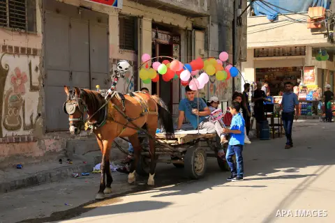 Palestinian children enjoy the first day of Eid al-Fitr holiday which marks the end of the Muslim holy month of Ramadan, in al-Bureij in the center of Gaza Strip on June 15, 2018. Eid al-Fitr marks the end of Muslim's ho...