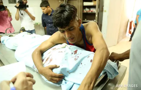 The brother of Sabri Abu Khadir 24, mourns over his body at the morgue of Al-Shifa Hospital in Gaza City on June 18, 2018. A Palestinian was killed by Israeli fire near the Gaza Strip's border with Israel, the health min...