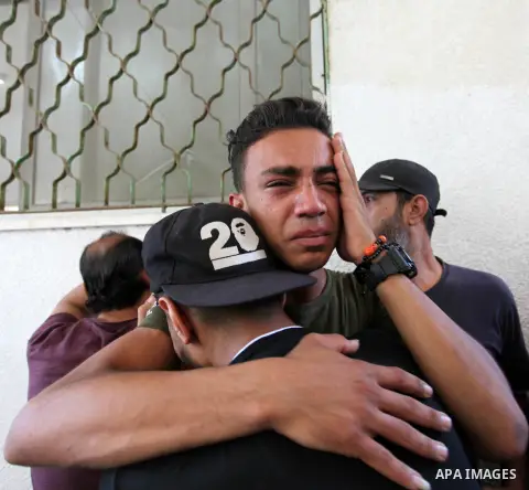 Relatives of Sabri Abu Khadir 24, mourns over his body at the morgue of Al-Shifa Hospital in Gaza City on June 18, 2018. A Palestinian was killed by Israeli fire near the Gaza Strip's border with Israel, the health minis...