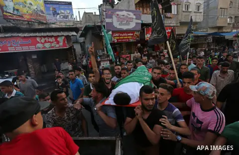 Mourners carry the body of Palestinian of Zakaria Beshbesh, 13, who died of his wounds endured during clashes with Israeli troops in a tent city protest where Palestinians demand the right to return to their homeland at...