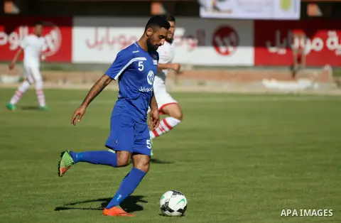 Palestinian players of Hilal al-Quds football club (in blue) compete with Palestinian players of Shabab Khan Younis football club (in white) during the first leg football match of the Palestine Cup final at the Palestine...