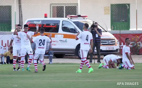 Palestinian players of Hilal al-Quds football club (in blue) compete with Palestinian players of Shabab Khan Younis football club (in white) during the first leg football match of the Palestine Cup final at the Palestine...