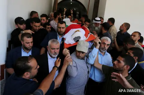 Mourners carry the body of 14-year-old Palestinian boy Yasser Abu Al-Naja, who was killed by Israeli troops during clashes in tents protest where Palestinian demand the right to return to their homeland at the Israel-Gaz...