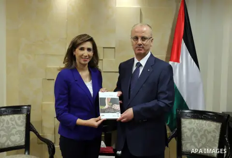 Palestinian Prime Minister Rami Hamdallah, receives the annual report of statistics and the national strategy for the development of official statistics, in the West Bank city of Ramallah on July 1, 2018. Photo by Prime...