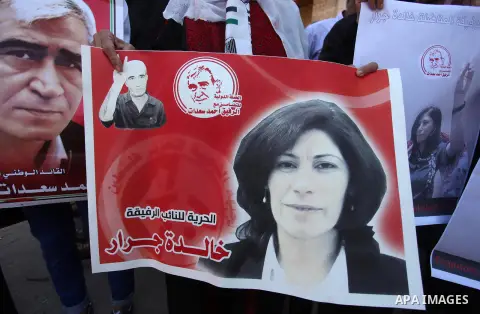 Palestinians take part a protest to show solidarity with the Leftist Legislator Khaleda Jarrar, in front of Red cross office in Gaza city on July 2, 2018. Photo by Mahmoud Ajour