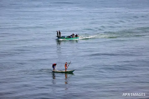 Palestinian fishermen ride their boat in the Mediterranean sea on the coast of Deir al-Balah, in the center of Gaza Strip on July 3, 2018. Photo by Atia Darwish