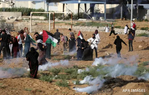 Palestinian women gather during a protest where Palestinians demand the right to return to their homeland along the border with Israel east of Gaza City on July 3, 2018. Photo by Ashraf Amra
