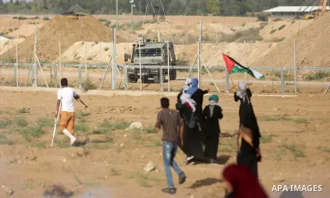 Palestinian women gather during a protest where Palestinians demand the right to return to their homeland along the border with Israel east of Gaza City on July 3, 2018. Photo by Ashraf Amra