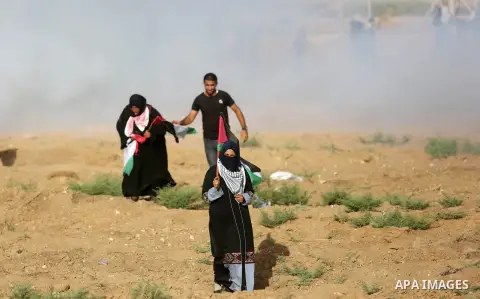 Palestinian women gather during a protest where Palestinians demand the right to return to their homeland along the border with Israel east of Gaza City on July 3, 2018. Photo by Ashraf Amra