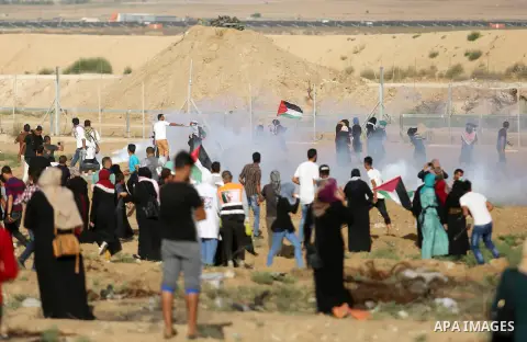 Palestinian women gather during a protest where Palestinians demand the right to return to their homeland along the border with Israel east of Gaza City on July 3, 2018. Photo by Ashraf Amra