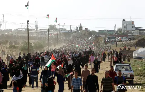 Palestinian women gather during a protest where Palestinians demand the right to return to their homeland along the border with Israel east of Gaza City on July 3, 2018. Photo by Atia Darwish