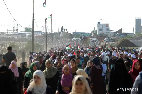 Palestinian women gather during a protest where Palestinians demand the right to return to their homeland along the border with Israel east of Gaza City on July 3, 2018. Photo by Atia Darwish