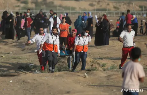 Protesters gather during a protest by Palestinian women where Palestinians demand the right to return to their homeland along the border with Israel east of Gaza City on July 3, 2018. Photo by Ashraf Amra