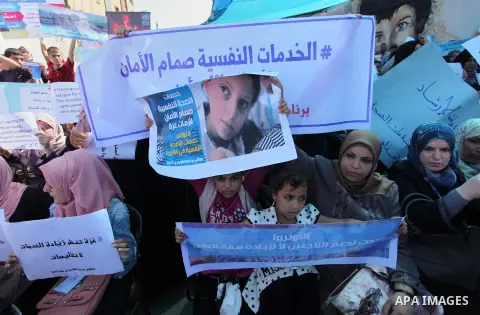 Palestinians hold banners during in a protest against a U.S. decision to cut aid, in front of the headquarters United Nations Relief and Works Agency (UNRWA), in Gaza City on July 4, 2018. Photo by Mahmoud Ajour