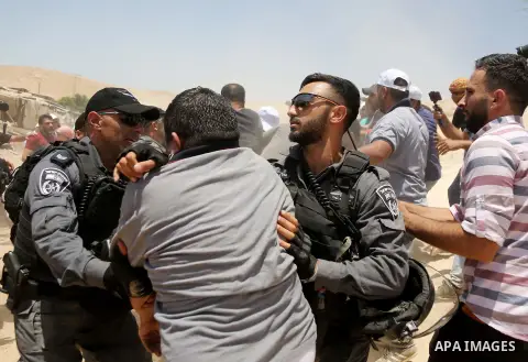 Israeli policemen scuffles with a Palestinian demonstrator in the Bedouin village of al-Khan al-Ahmar east of Jerusalem in the occupied West Bank on July 4, 2018. Residents and activists voiced concern today that Israel...