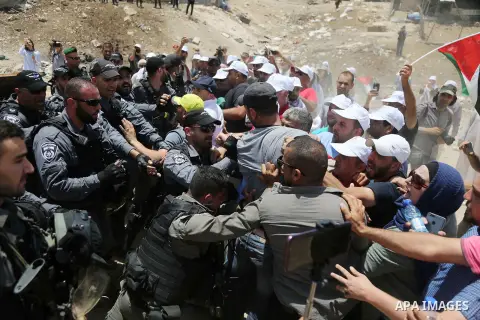 Israeli policemen scuffle with Palestinian demonstrators in the Bedouin village of al-Khan al-Ahmar east of Jerusalem in the occupied West Bank on July 4, 2018. Residents and activists voiced concern today that Israel is...