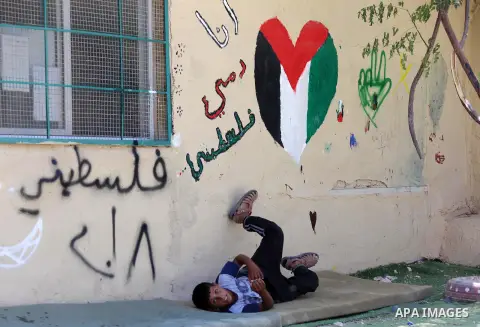 A Palestinian boy plays at the Palestinian Bedouin village of Khan al-Ahmar, east of Jerusalem in the occupied West Bank on July 6, 2018. Israel's Supreme Court has temporarily blocked the demolition of a Palestinian Bed...