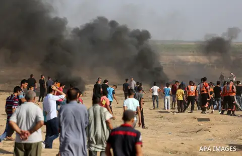 Palestinian protesters gather during clashes with Israeli troops in tents protest where Palestinian demand the right to return to their homeland at the Israel-Gaza border, in east of Gaza City on July 6, 2018. Photo by D...