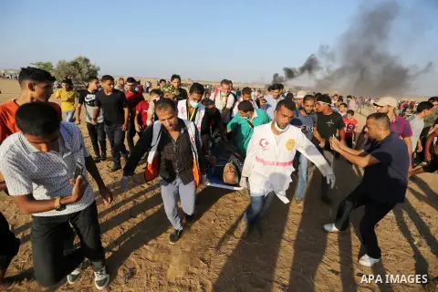 A wounded Palestinian protester is evacuated during clashes with Israeli troops in tents protest where Palestinian demand the right to return to their homeland at the Israel-Gaza border, in Khan Younis in the southern Ga...