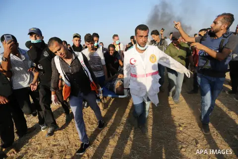 A wounded Palestinian protester is evacuated during clashes with Israeli troops in tents protest where Palestinian demand the right to return to their homeland at the Israel-Gaza border, in Khan Younis in the southern Ga...