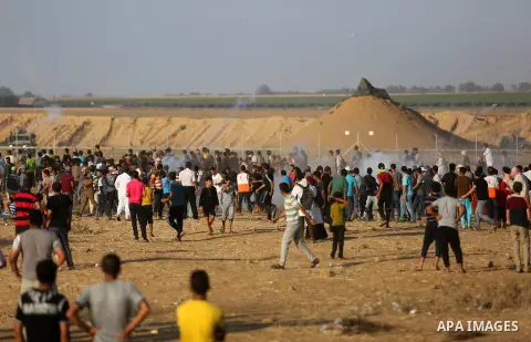 Palestinian protesters gather during clashes with Israeli troops in tents protest where Palestinian demand the right to return to their homeland at the Israel-Gaza border, in Khan Younis in the southern Gaza Strip on Jul...