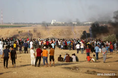 Palestinian protesters gather during clashes with Israeli troops in tents protest where Palestinian demand the right to return to their homeland at the Israel-Gaza border, in Khan Younis in the southern Gaza Strip on Jul...