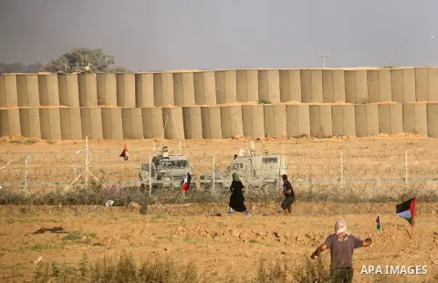 Palestinian protesters gather during clashes with Israeli troops in tents protest where Palestinian demand the right to return to their homeland at the Israel-Gaza border, in al-Bureij in the center of Gaza Strip on July...